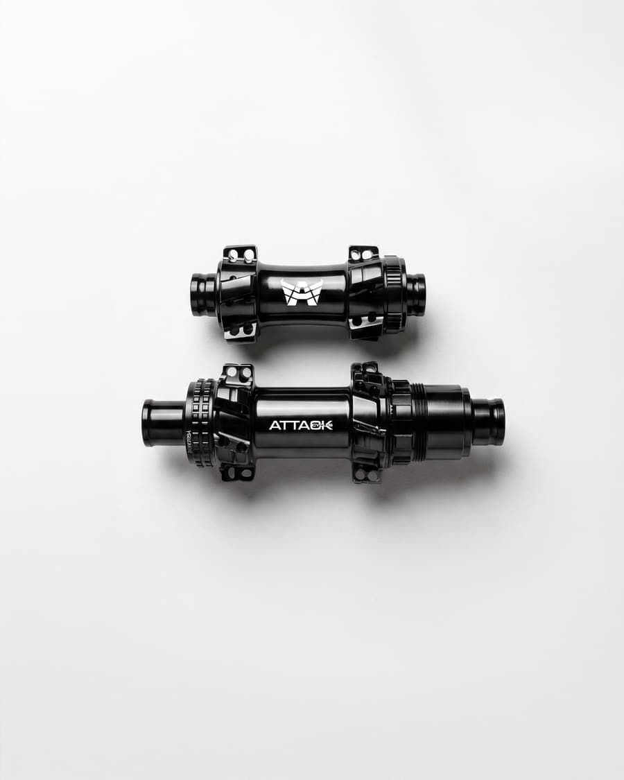 ATTACKCYCLES front and rear hubs side by side on a white background.
