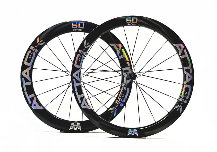 ATTACKCYCLES SuPrLt 5D/6D wheelset with silver rainbow decals, photographed at an angle.